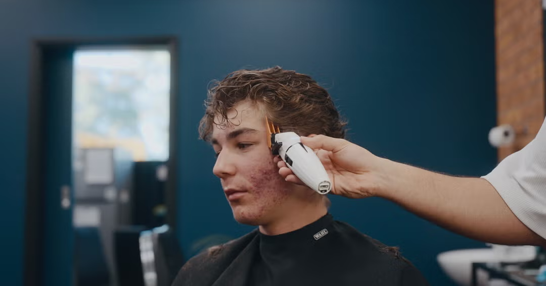 Barber giving a precision clipper cut at Craig's Barbershop Thornton
